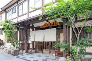 a building with a sign on the side of it at 全5室の小さな温泉旅館 別府鉄輪温泉 萬力屋 in Beppu +58 photos