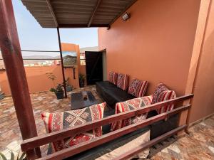 a porch with a couch and a table at Casa del sol Sidi Ifni in Sidi Ifni