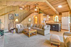 a living room with a couch and a table and a kitchen at Waterfront Escape on Big Sand Lake with Private Dock in Minong