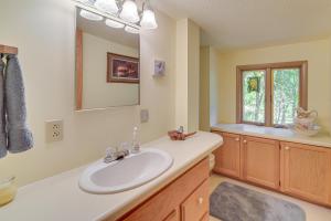 a bathroom with a sink and a mirror at Waterfront Escape on Big Sand Lake with Private Dock in Minong +37 photos