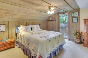 a bedroom with a bed and a wooden ceiling at Waterfront Escape on Big Sand Lake with Private Dock in Minong