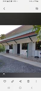 a picture of a building with tables and chairs at Teahouse in Ban Suan