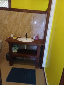a bathroom with a sink in a room at Hitirā Lodge presqu'île in Atihiva