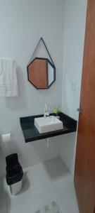 a bathroom with a sink and a mirror on the wall at Pousada Brisa Rio in Aracaju +23 photos