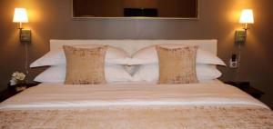 a large white bed with two pillows on it at Hotel Downtown Miami - DQR in Miami +1 photo