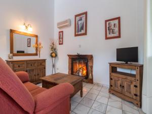 a living room with a couch and a fireplace at Spacious Countryside Retreat with Pool in Cuenca