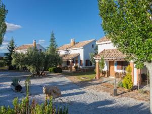 a large white house with trees in front of it at Vacation Home for 6 near Bolera Reservoir in Cuenca
