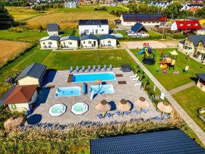 an aerial view of a backyard with a pool at Comfortable holiday homes, pool and whirlpool in Ustronie Morskie +15 photos