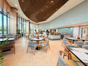 a restaurant with tables and chairs and a cafeteria at Villa Private Pool in Cam Lâm