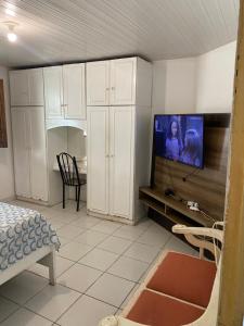 a living room with a flat screen tv on a wall at Hostel Manga Rosa Stm in Santarém