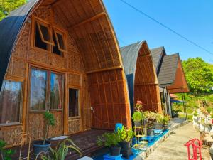 a house that is made out of wood at Pondok Indah Teluk Asmara in Roworante