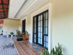 a room with large windows and a table and chairs at Pondok Indah Teluk Asmara in Roworante