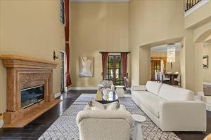 a living room with white furniture and a fireplace at 5800 sq ft Gorgeous Tarzana 7 bedroom 9 bathroom home with pool and hot tub in Tarzana