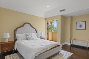 a bedroom with a large bed and a window at 5800 sq ft Gorgeous Tarzana 7 bedroom 9 bathroom home with pool and hot tub in Tarzana +42 photos