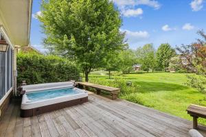 un bain à remous sur une terrasse avec un banc dans l'établissement Landmark Meadows, à Stowe Fork