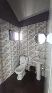 a bathroom with a toilet and a sink at Grace Riverfront in Lat Krabang