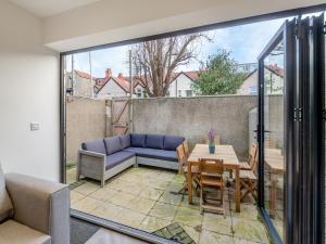 a patio with a couch and a table and chairs at Townhouse in Llandudno +18 photos