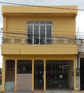 a yellow building with a balcony on top of it at CASA DO VOVÔ centro Belém in Belém