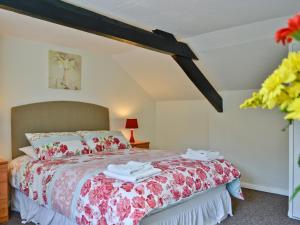 a bedroom with a bed with towels on it at The Lodge - 29794 in Swimbridge
