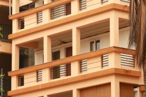 a building with many windows on the side of it at Goa Fiesta in Arpora