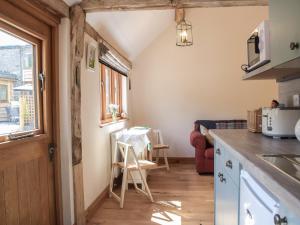 a kitchen with a counter and a table in a room at Gooses Roost - Uk32096 in Dorstone
