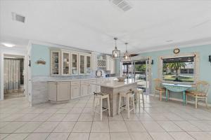 a kitchen with a table and chairs and a sink at Waterfront Retreat with Pool Tiki Bar & Boat Dock in Bon Terra +62 photos