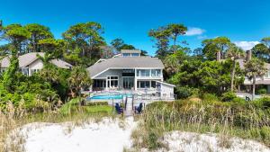 a house on the beach from the dunes at Oceanfront 7 BR 7 BA Wonderful Pool Deck Beach gear and bike rentals included in Hilton Head Island