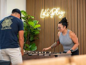 a man and a woman standing next to a keyboard at Fine Design | 14 Guest | Sauna | HotTub | Firepit in Southern Shops