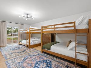 two bunk beds in a room with a rug at Fine Design | 14 Guest | Sauna | HotTub | Firepit in Southern Shops +49 photos