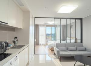 a kitchen and living room with a couch and a bed at Sokcho Whalejib The Blue Terra Ocean Stay in Puwŏl-li +10 photos