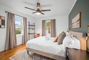a bedroom with a bed and a ceiling fan at 9mi To NRG | Game Room | Hot Tub | Firepit | Grill in Oak Hill
