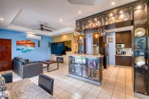 a living room with a couch and a table at Hacienda Iguana Luxury Apartment with Pool & Golf in Tola