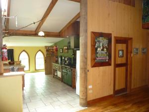 a large kitchen with green appliances and wooden walls at Lovely rural 3 bedroom home near the Kahurangi NP 