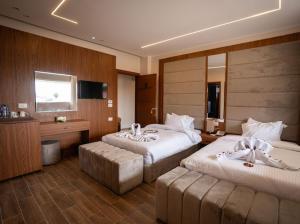 a hotel room with two beds and a television at Dar Atom pyramids in Cairo
