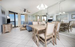 a dining room and living room with a table and chairs at Phoenix VI 61004 in Orange Beach