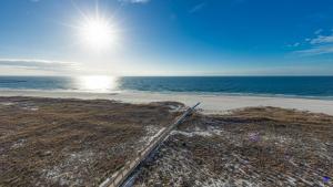 an aerial view of a beach with the sun in the sky at Phoenix VI 61004 in Orange Beach +53 photos