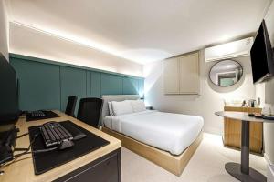 a room with a bed and a desk with a computer at Hotel Yam - Paju Geumchon in Paju