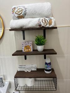 łazienka z drewnianymi półkami na ręczniki i umywalką w obiekcie Dainty Den LF508 - Comfy & Chic Home beside Enchanted Kingdom w mieście Santa Rosa
