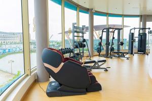a gym with treadmills and chairs in a building at Toàn Cầu Hotel Quảng Bình in Dong Hoi
