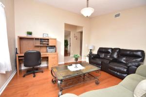 a living room with a leather couch and a table at Cozy Family Pool Home in Palm Coast in Palm Coast