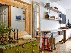 a room with a desk and a table with a mirror at The Rise in Scarborough