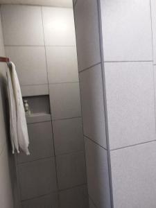 a bathroom with a shower stall with a towel at Mamay's Place Homestay in Tagbilaran City +13 photos
