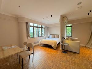 a bedroom with a bed and a table and chairs at The Keystone Clarke Quay in Singapore