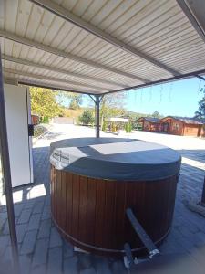 a large hot tub under a cover on a patio at Відпочинкова база " На Нивці" in Stilskoye +2 photos