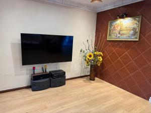 a living room with a flat screen tv on a wall at Kas Villa Homestay JB in Johor Bahru