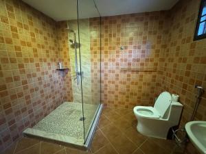 a bathroom with a shower with a toilet and a sink at Kas Villa Homestay JB in Johor Bahru +13 photos