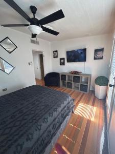 a bedroom with a bed and a flat screen tv at Estudio práctico y confortable en segundo piso in Senecú