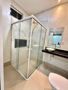 a bathroom with a shower and a toilet and a sink at Casa da Anita in Boa Vista