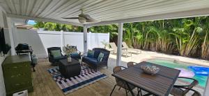 a patio with a table and chairs and a pool at Family Pool Home Close to Naples' Best Beaches in Naples