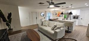 a living room with a couch and a kitchen at Family Pool Home Close to Naples' Best Beaches in Naples